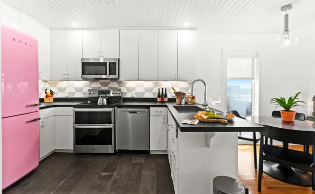 a kitchen with stainless steel appliances kitchen island granite countertop a sink stove and cabinets