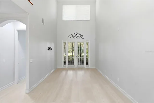 a view of a hallway with a white walls and chandelier