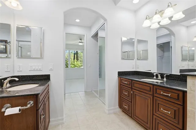 a view of a hallway with a ceiling fan