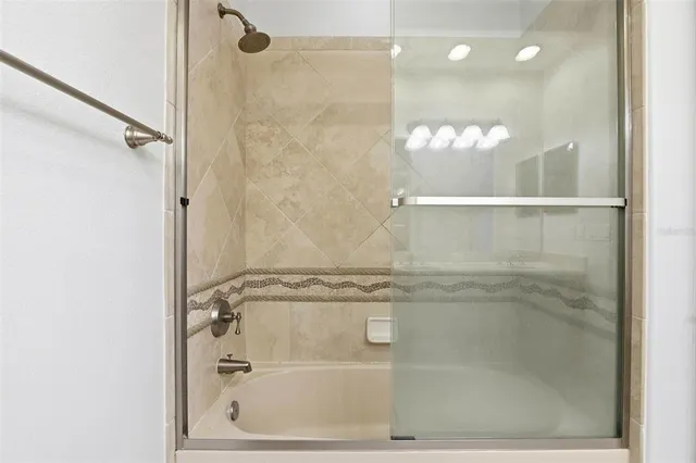 a bathroom with a sink a mirror and shower