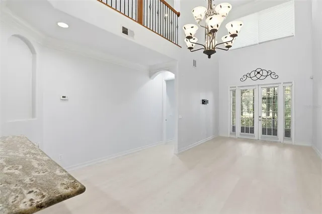 a view of a hallway with chandelier