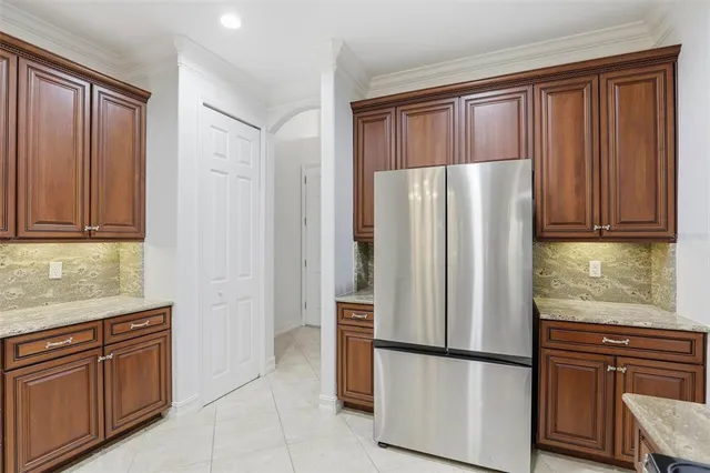 a kitchen with stainless steel appliances granite countertop wooden cabinets a granite counter and a sink