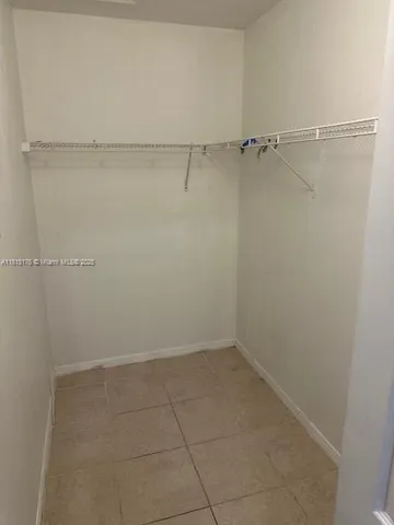 a white refrigerator freezer and a stove sitting inside of a kitchen with granite countertop appliances