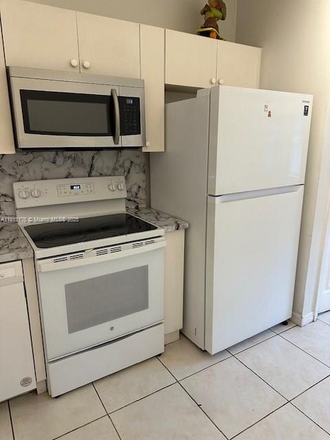 Homestead Homestead, FL 33035 - Photo 13 of 14 a white refrigerator freezer and a stove sitting inside of a kitchen with granite countertop appliances