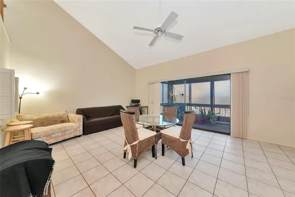a living room with furniture and a floor to ceiling window