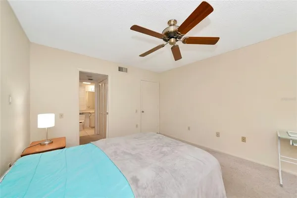 a bedroom with a bed and a mirror