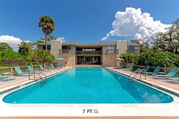 a view of swimming pool with a garden and plants