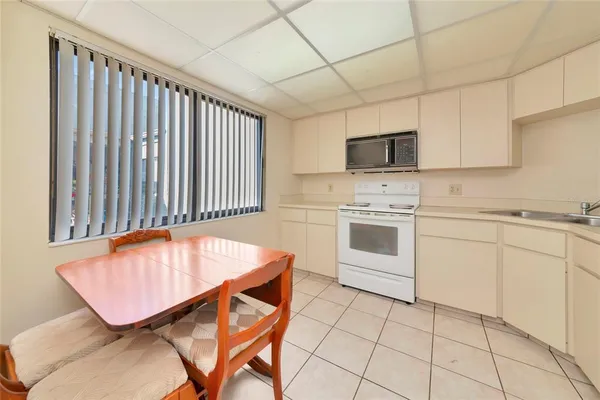 a kitchen with a stove a sink and a refrigerator