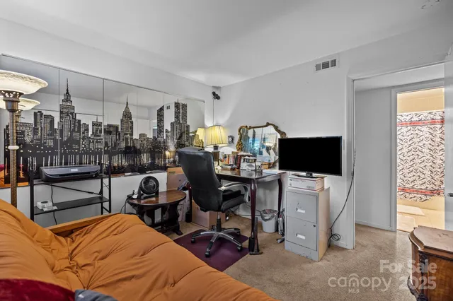 a bedroom with a workspace