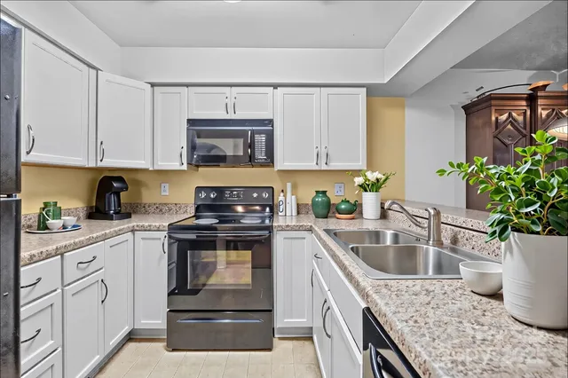 a kitchen with sink cabinets and stove