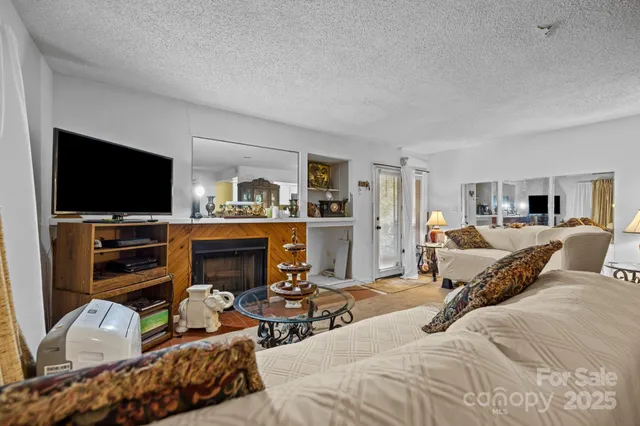 a bedroom with furniture and a flat screen tv