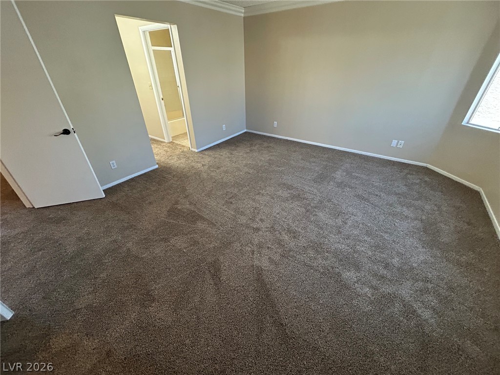 2806 Rungsted Street Las Vegas, NV 89142 - Photo 18 of 18 A spacious bedroom with plush carpeting and natural light from a sloped window.