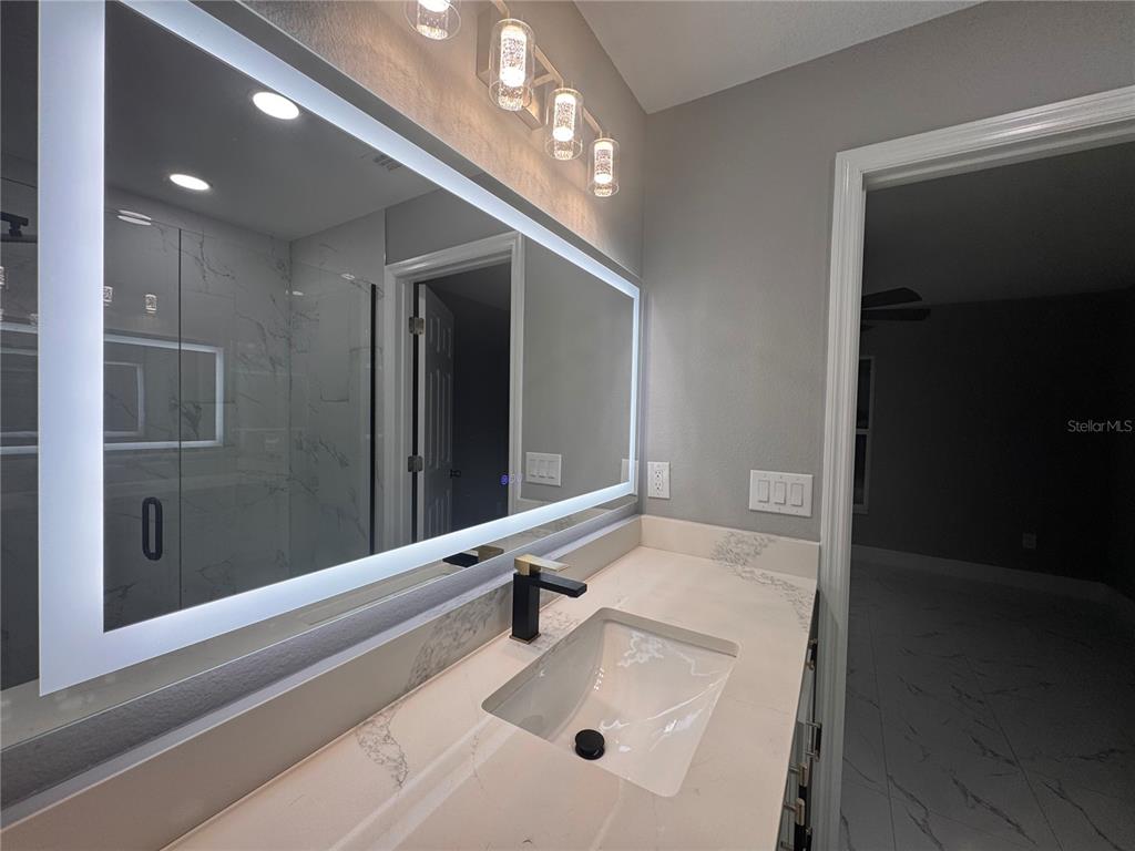 17313 Southwest 27 Street Dunnellon, FL 34432 - Photo 11 of 20 a bathroom with a sink tub and shower