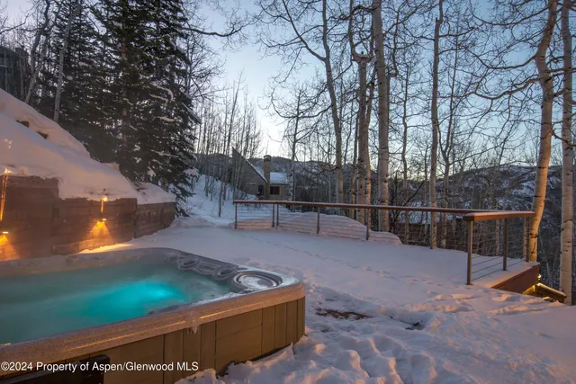 a view of a backyard with wooden fence
