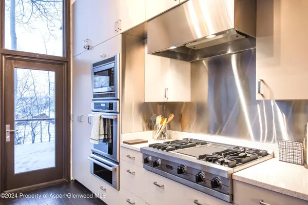 a kitchen with stainless steel appliances granite countertop a stove and a refrigerator