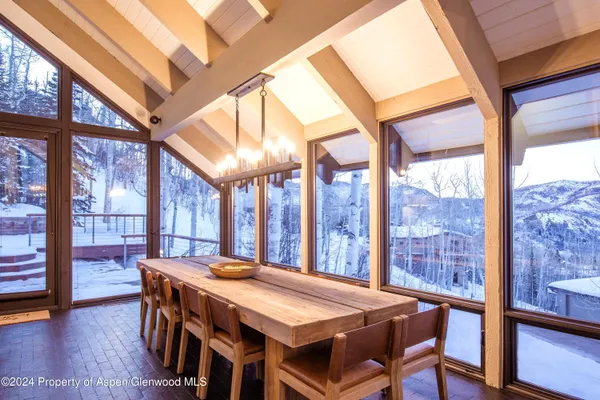 a dining room with a table and chairs
