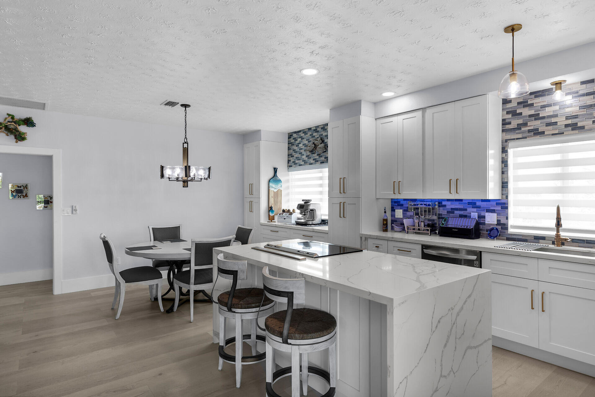 30363 Flamingo Lane Big Pine Key, FL 33043 - Photo 13 of 43 a kitchen with stainless steel appliances a dining table chairs and a hard wood floor
