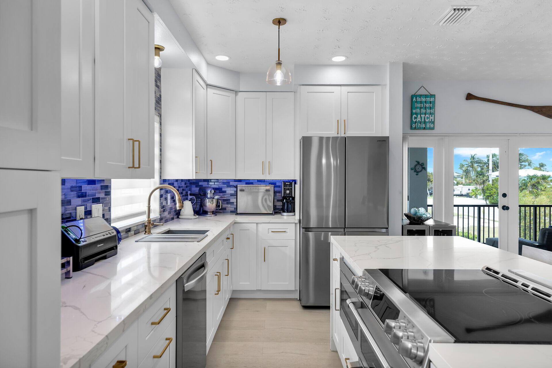 30363 Flamingo Lane Big Pine Key, FL 33043 - Photo 16 of 43 a kitchen with a sink stove and refrigerator