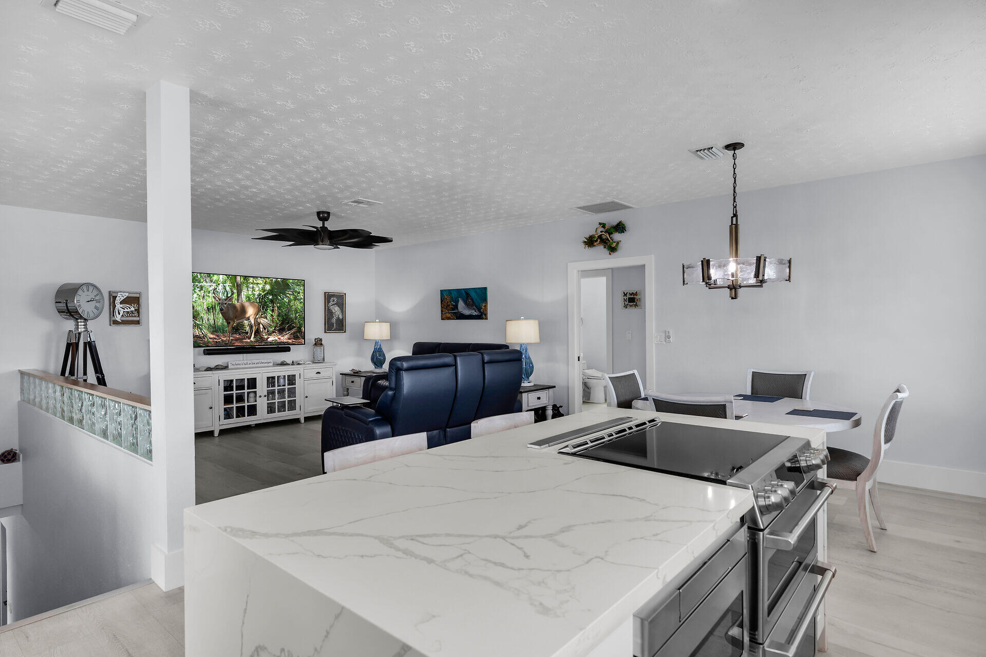 30363 Flamingo Lane Big Pine Key, FL 33043 - Photo 17 of 43 a kitchen with a sink a stove and chairs