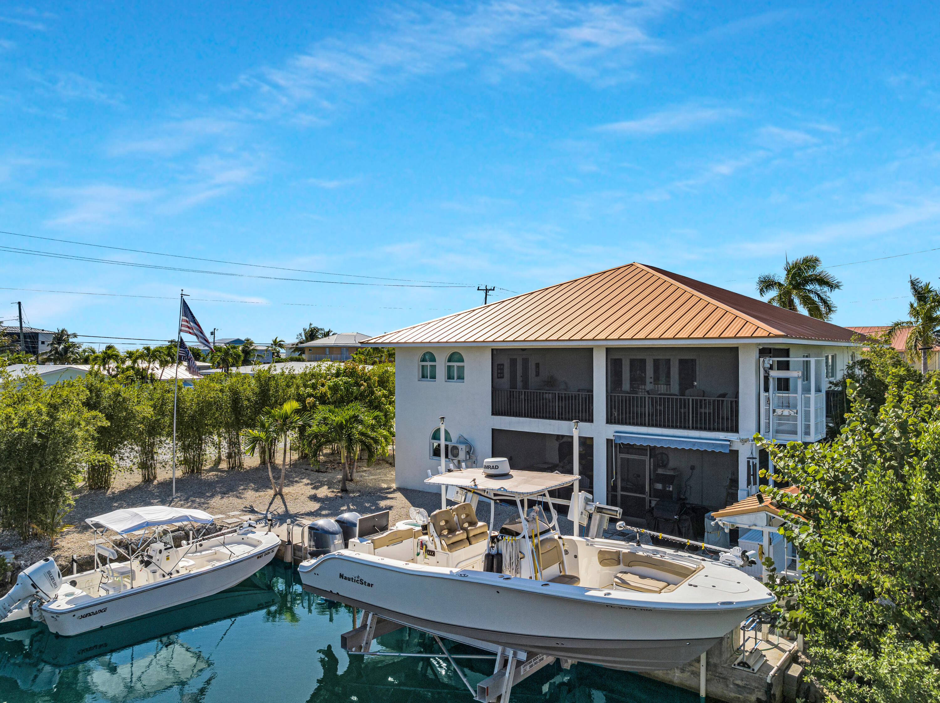 30363 Flamingo Lane Big Pine Key, FL 33043 - Photo 3 of 43 a view of a patio with couches table and chairs and potted plants