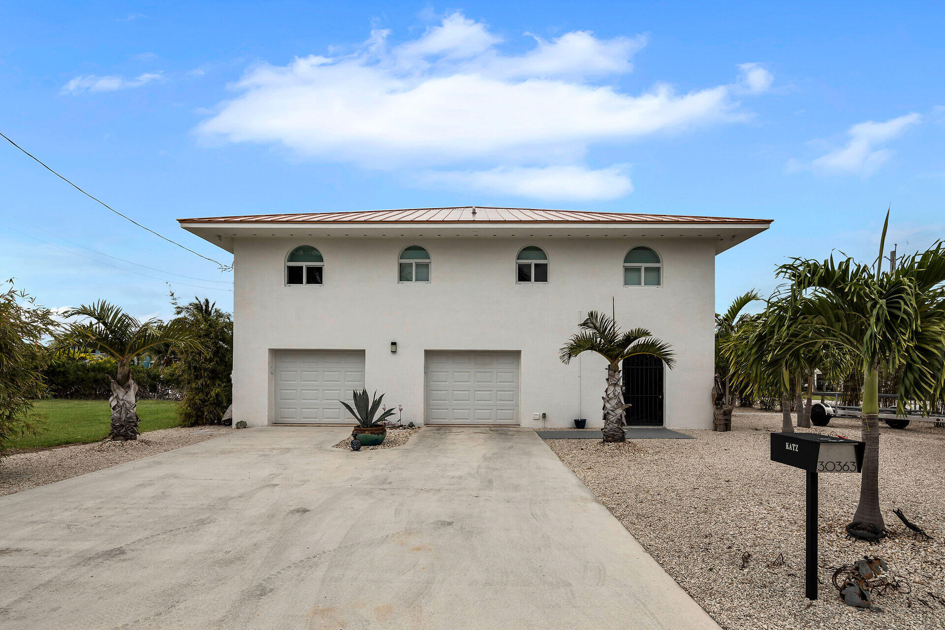 30363 Flamingo Lane Big Pine Key, FL 33043 - Photo 7 of 43 a view of a white house with a yard and plants