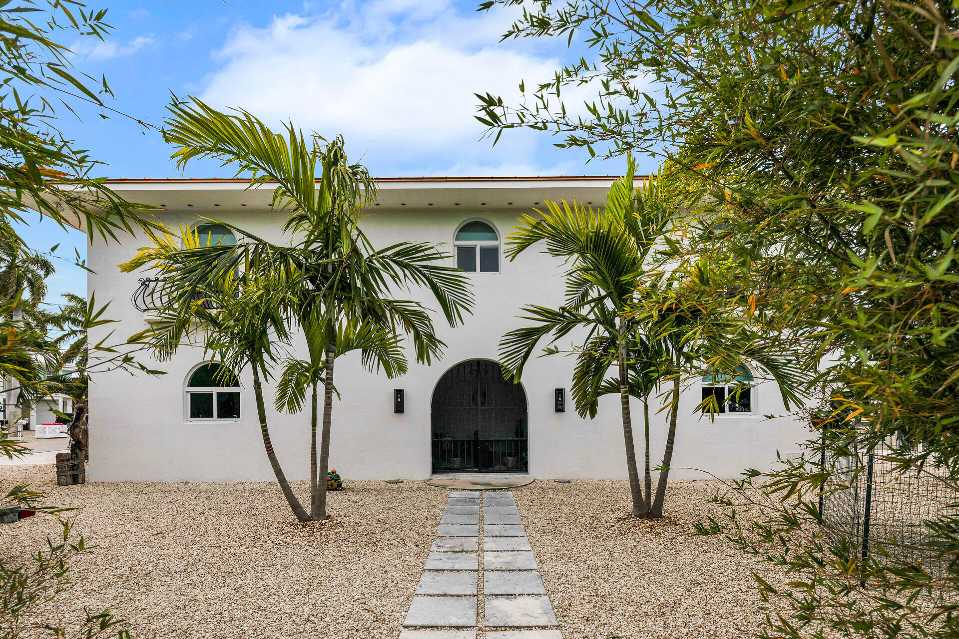 30363 Flamingo Lane Big Pine Key, FL 33043 - Photo 9 of 43 a front view of a house with a garden