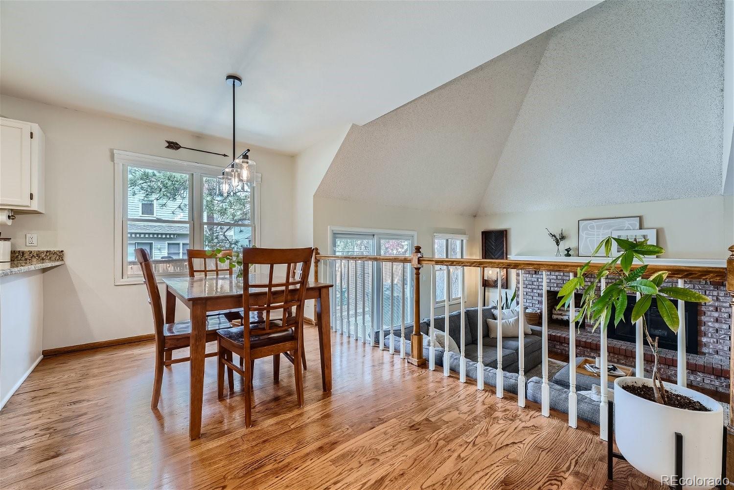 16671 East Prentice Circle Centennial, CO 80015 - Photo 13 of 40 a dining room with furniture potted plants and wooden floor
