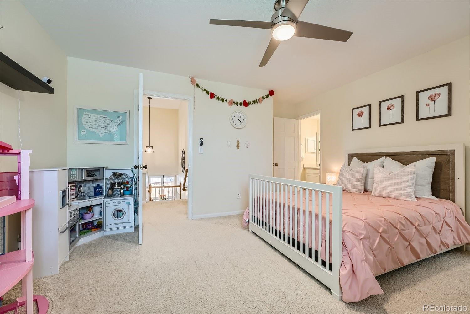 16671 East Prentice Circle Centennial, CO 80015 - Photo 21 of 40 a bedroom with a bed and a walk in closet
