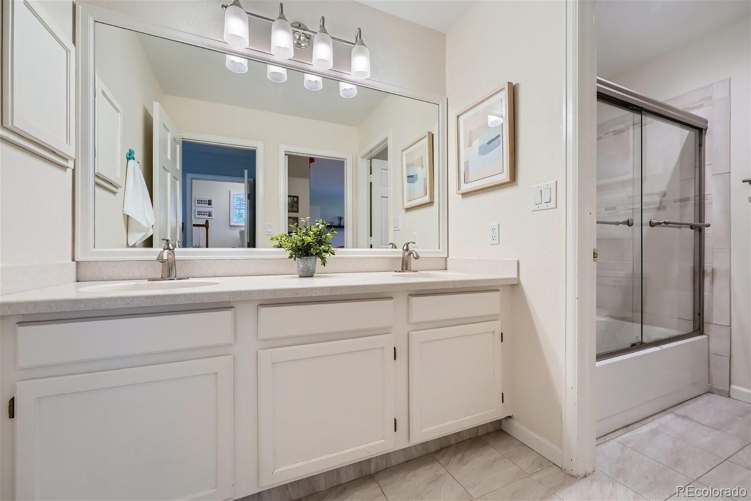 16671 East Prentice Circle Centennial, CO 80015 - Photo 25 of 40 a bathroom with a double vanity sink and a mirror
