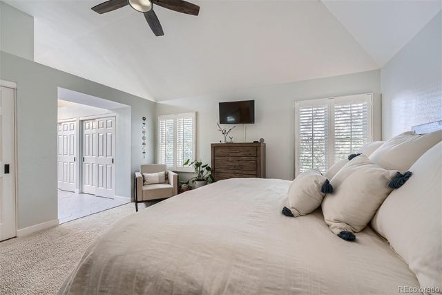 a spacious bedroom with a bed and a cabinets