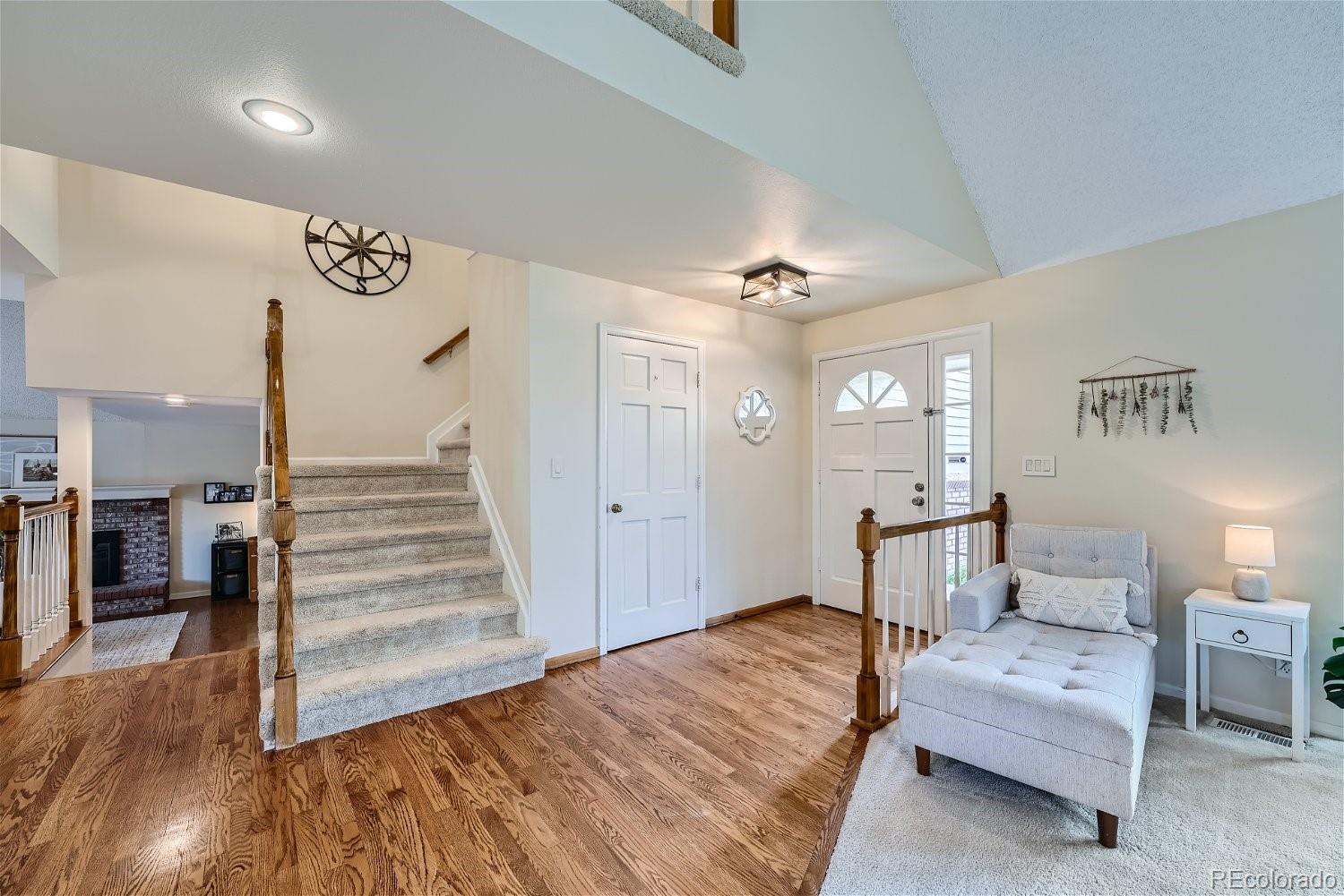 16671 East Prentice Circle Centennial, CO 80015 - Photo 3 of 40 a spacious bedroom with a bed and a chandelier