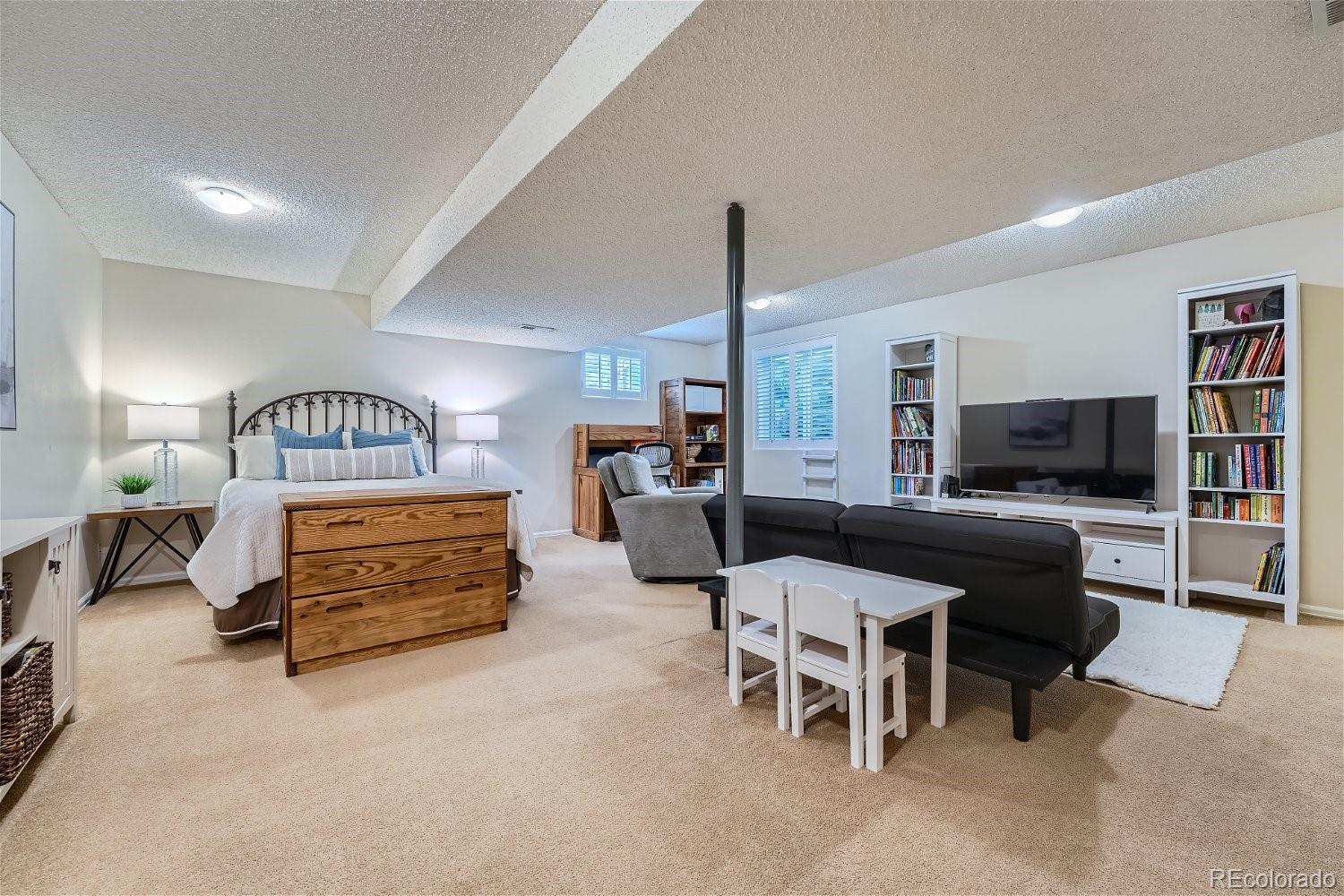 16671 East Prentice Circle Centennial, CO 80015 - Photo 33 of 40 a living room with furniture a flat screen tv and a table
