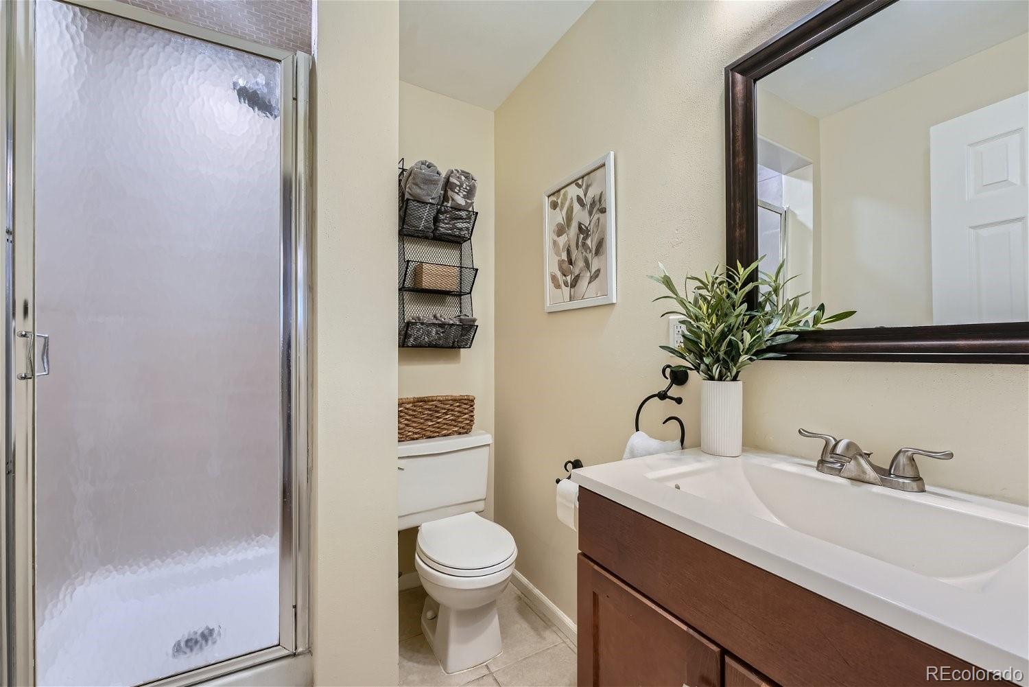 16671 East Prentice Circle Centennial, CO 80015 - Photo 36 of 40 a bathroom with a sink a toilet and shower