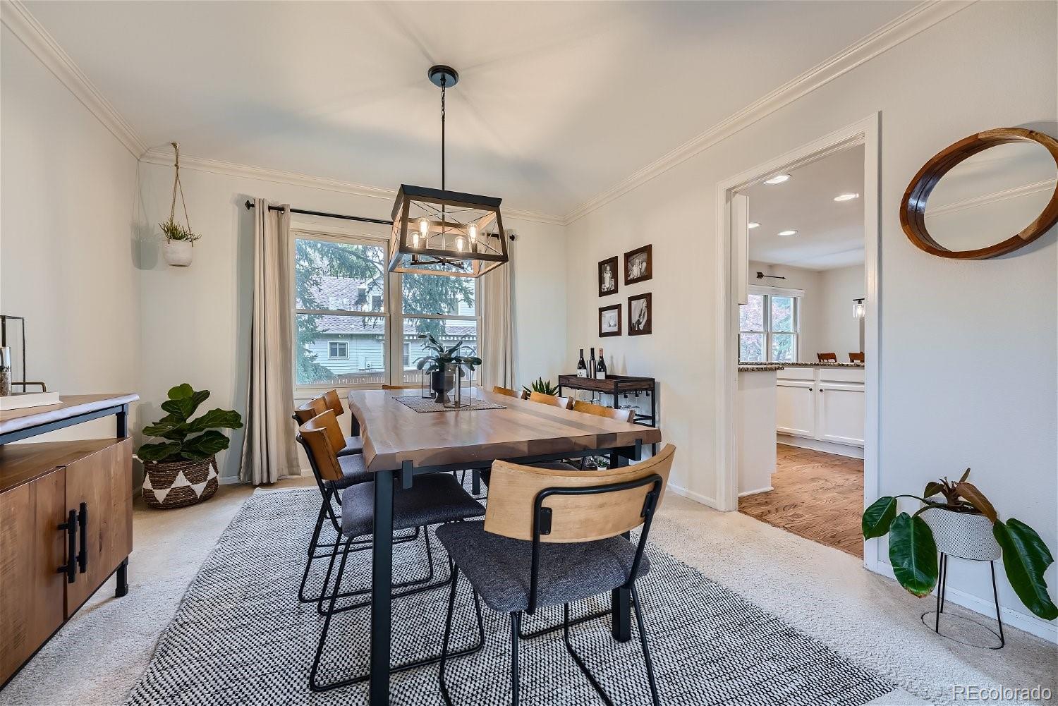 16671 East Prentice Circle Centennial, CO 80015 - Photo 8 of 40 a view of a dining room and livingroom with furniture wooden floor a chandelier