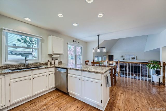 a kitchen with lots of counter top space sink and stainless steel appliances