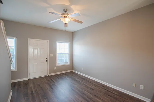 wooden floor in an empty room with a window