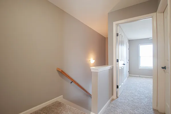 a view of a hallway with white walls