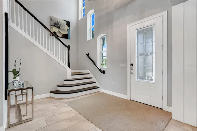 a large kitchen with cabinets and chairs