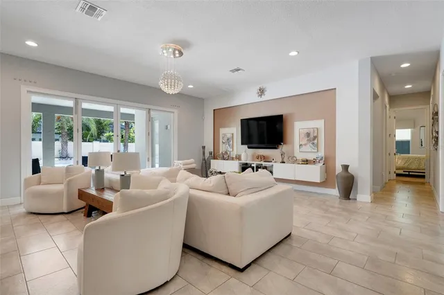 a dining room with furniture a chandelier and window