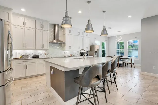 a spacious bedroom with a bed a couch and a flat tv screen