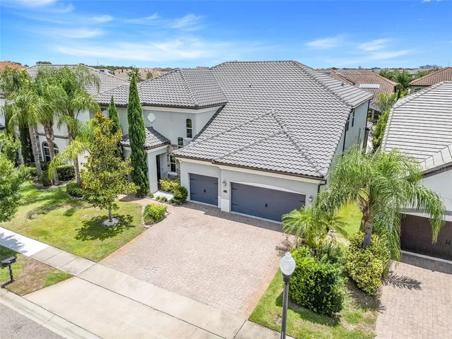 a dining room with furniture a chandelier and window