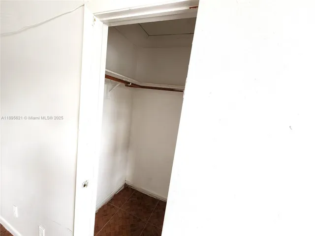 a view of empty room with ceiling fan