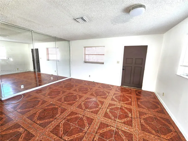 a bedroom with a large bed and a walk in closet