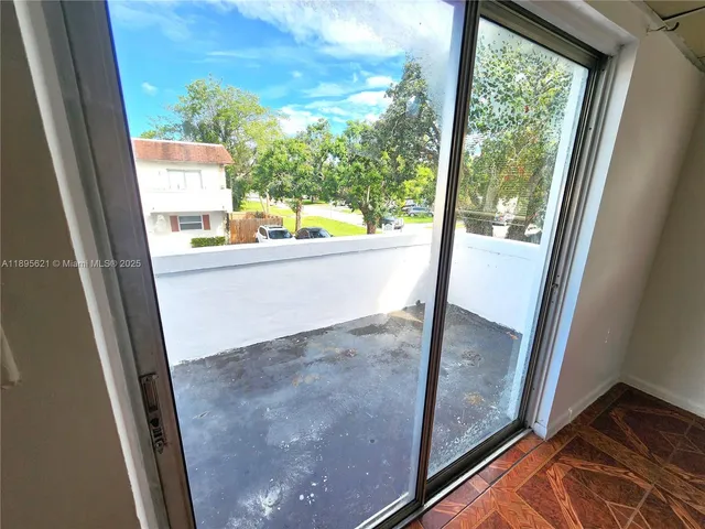 a kitchen with a sink a refrigerator a window and a counter top space