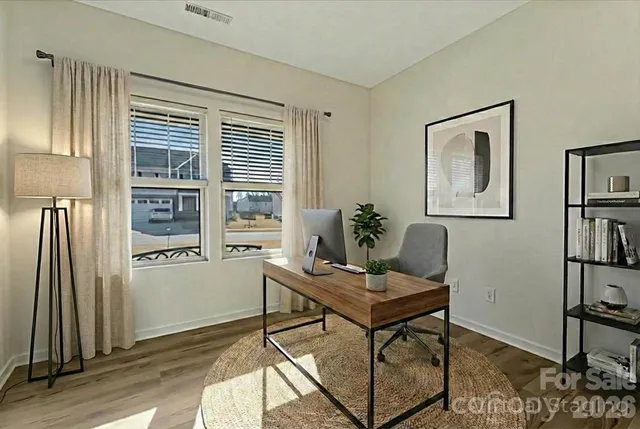 a view of a small space with wooden floor and a window