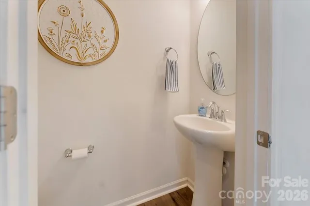 a kitchen with stainless steel appliances a refrigerator a sink a stove a dining table and chairs