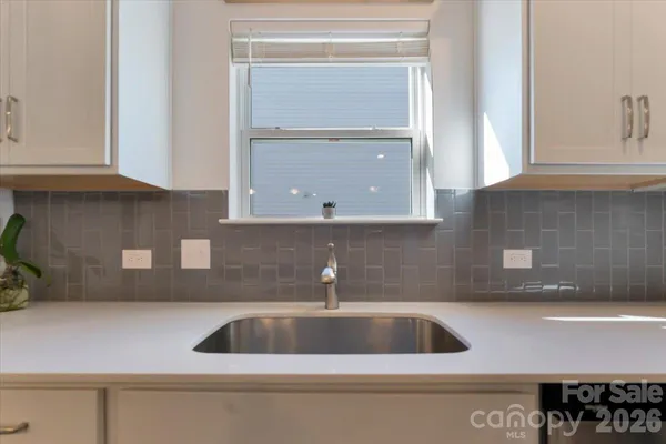 a kitchen with a sink and cabinets