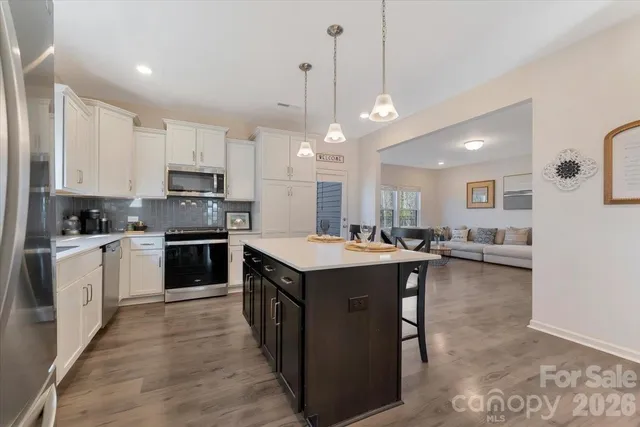 a living room with furniture wooden floor and a flat screen tv