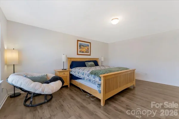 a bedroom with a bed and a lamp