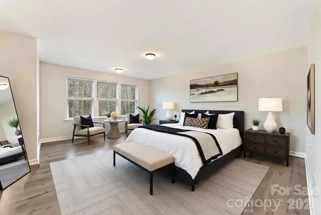 a bedroom with a large bed and a window